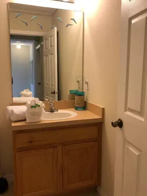 a bathroom with a sink and a mirror at Gated Emerald island resort townhome, Overlook Pool, 3 miles to Disney, rent by owner in Kissimmee