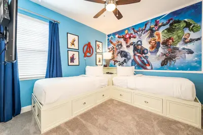 two beds in a marvel bedroom with blue walls at Elegant Home Near Disney With Private Pool, Foosball Table, Themed Rooms And Waterpark & Resort Access At Encore Resorts Reunion - 365Sf in Kissimmee