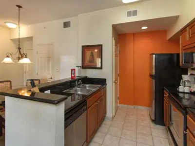 a kitchen with a sink and a black refrigerator at Luxury Resort Condo, 2 or 3 BR, Premium suites in Orlando