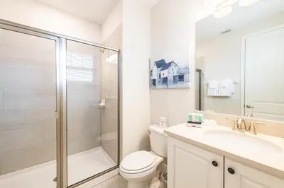 a bathroom with a toilet sink and a shower at Spacious Home With Game Room, Private Pool And Waterpark & Resort Access Near Disney At Encore Resorts Reunion - 241Sf in Kissimmee