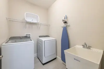 a laundry room with a washing machine and a sink at Spacious Home With Game Room, Private Pool And Waterpark & Resort Access Near Disney At Encore Resorts Reunion - 241Sf in Kissimmee
