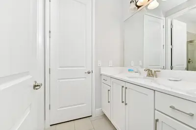 a white bathroom with a sink and a mirror at Modern Home Near Disney With Private Pool, Media, Game & Themed Rooms With Waterpark & Resort Access At Encore Resorts Reunion - 384Sf in Kissimmee