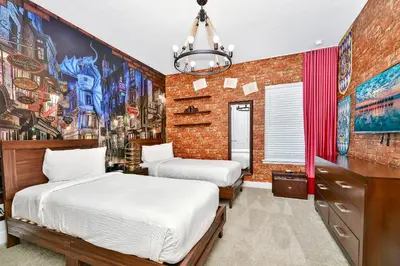 a bedroom with two beds and a brick wall at Modern Home Near Disney With Private Pool, Media, Game & Themed Rooms With Waterpark & Resort Access At Encore Resorts Reunion - 384Sf in Kissimmee