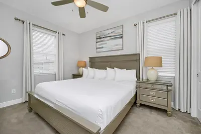 a bedroom with a bed and a ceiling fan at Grand Home Near Disney With Private Pool, Air Hockey Table And Waterpark & Resort Access At Encore Resorts Reunion - 401Sf in Kissimmee