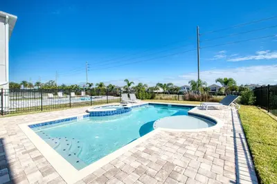 a swimming pool in the backyard of a house at Lovely Home Near Disney With Private Pool, Foosball Table And Waterpark & Resort Access At Encore Resorts Reunion - 408Sf in Kissimmee