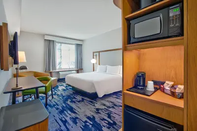 a hotel room with a bed and a tv at Fairfield by Marriott Inn & Suites Orlando at FLAMINGO CROSSINGS® Town Center in Orlando