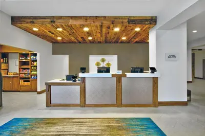 an office lobby with a reception desk and a rug at Fairfield by Marriott Inn & Suites Orlando at FLAMINGO CROSSINGS® Town Center in Orlando