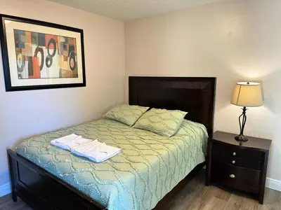 a bedroom with a bed and a lamp and a picture at Grand Family Premium 3BR Condo near Disney Parks in Kissimmee