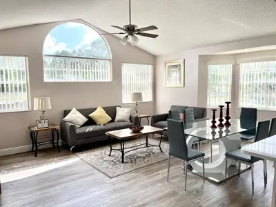 a living room with a couch and a table at Grand Family Premium 3BR Condo near Disney Parks in Kissimmee