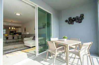 a dining room with a white table and chairs at Luxurious 2 Bd Close to Disney @ Storey Lake 204P in Kissimmee