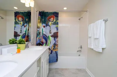 a white bathroom with a shower and a sink at Luxurious 2 Bd Close to Disney @ Storey Lake 204P in Kissimmee