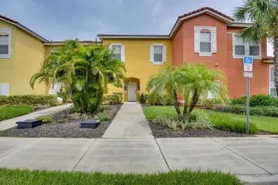 a house with palm trees in front of it at Near Disney and Epic Universe Home with Resort Perks in Kissimmee