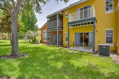 a house with a green lawn in front of it at Near Disney and Epic Universe Home with Resort Perks in Kissimmee