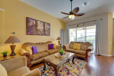 a living room with couches and a table at Pool, Themed Rooms and Arcade Disney Escape in Kissimmee