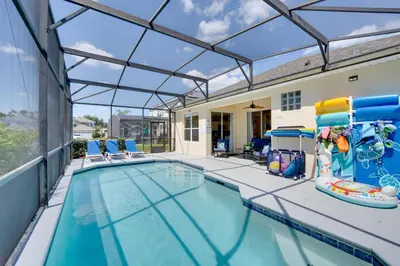 an indoor swimming pool with a glass ceiling at Pool, Themed Rooms and Arcade Disney Escape in Kissimmee