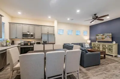 a kitchen and living room with a table and chairs at Cocktails & Dreams Cottage With Private Pool Near Disney With Margaritaville Resort & Island H2O Access - 8005St in Orlando