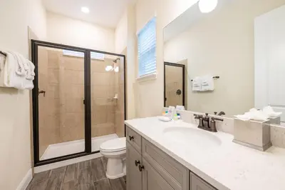 a bathroom with a sink and a toilet and a shower at Cocktails & Dreams Cottage With Private Pool Near Disney With Margaritaville Resort & Island H2O Access - 8005St in Orlando