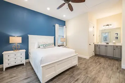 a bedroom with a white bed and a blue wall at Comfy Cottage Near Disney With Margaritaville Resort & Island H2O Access - 8087Kd in Orlando