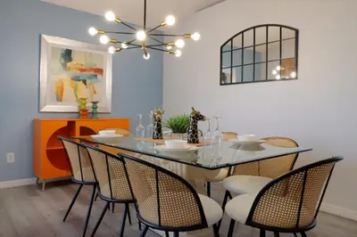 a dining room with a glass table and chairs at Making Dreams 4BR Family Villa with Pool and Game Room Near Disney Parks in Kissimmee
