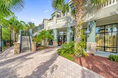 a house with palm trees and a driveway at Spacious 3BR Near Disney - Pool in Orlando