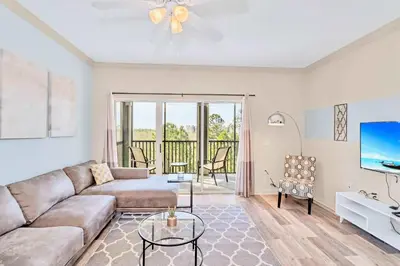 a living room with a couch and a tv at Spacious 3BR Near Disney - Pool in Orlando