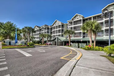 an empty street in front of a building with palm trees at Bright & Airy 3BR Suite Near Disney - Pool in Orlando