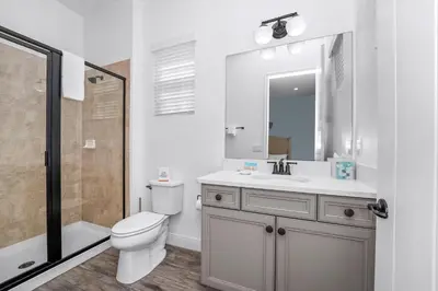 a bathroom with a toilet and a sink and a shower at Pineapple Dream Cottage With Private Hot Tub Near Disney With Margaritaville Resort & Island H2O Access - 8000Sb in Orlando