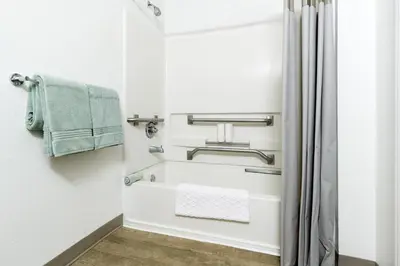 a bathroom with a towel rack and a shower at InTown Suites Extended Stay Orlando FL – Presidents Dr in Orlando
