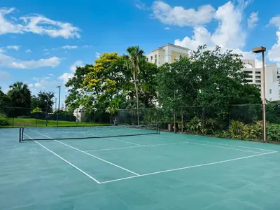 a tennis court with a net on it at Modern Studio on I-Drive: parking + pool included in Orlando