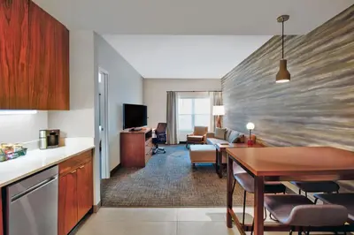 a hotel room with a kitchen and a dining room at Residence Inn by Marriott Orlando at FLAMINGO CROSSINGS Town Center in Orlando