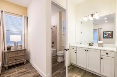 a white bathroom with a sink and a toilet at Brilliant Cottage With Private Pool Near Disney With Margaritaville Island H2O Access - 8033St in Orlando
