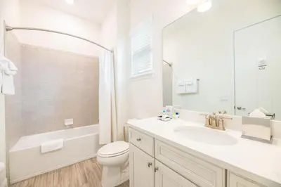 a white bathroom with a sink and a toilet at Vivid Cottage Near Disney With Margaritaville Resort & Island H2O Access - 8020Ff in Orlando