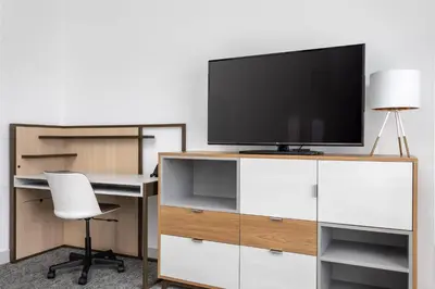 an office with a desk with a tv and a chair at TownePlace Suites By Marriott Orlando Southwest Near Universal in Orlando