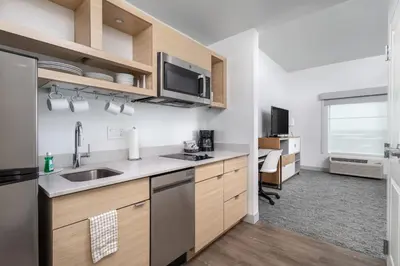 a kitchen with a sink and a microwave at TownePlace Suites By Marriott Orlando Southwest Near Universal in Orlando