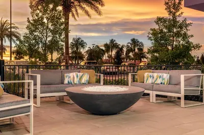 a patio with two couches and a coffee table at TownePlace Suites By Marriott Orlando Southwest Near Universal in Orlando