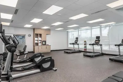 a gym with treadmills and ellipticals in a room at TownePlace Suites By Marriott Orlando Southwest Near Universal in Orlando
