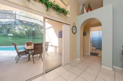 a dining room with sliding glass doors and a table at bsv_villa1607 in Orlando