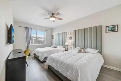 a bedroom with two beds and a ceiling fan at Luxury 3BR resort Condo walking distance to Epic Universe, Convention center and Icon Park in Orlando