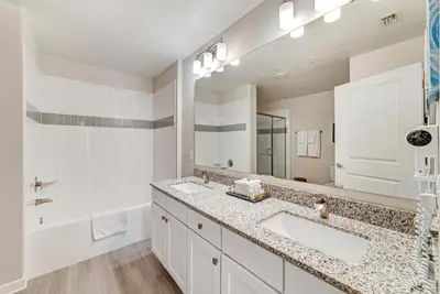 a bathroom with two sinks and a large mirror at Luxury 3BR resort Condo walking distance to Epic Universe, Convention center and Icon Park in Orlando