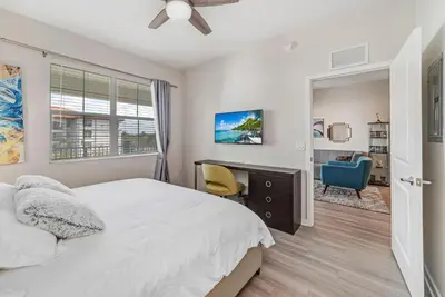 a bedroom with a bed and a desk and a chair at Luxury 3BR resort Condo walking distance to Epic Universe, Convention center and Icon Park in Orlando