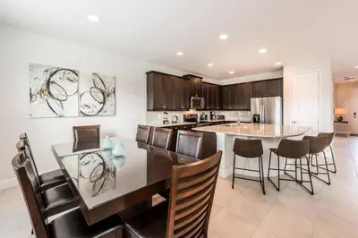 a kitchen and dining room with a table and chairs at Encore Resort 5 Bedroom Home with Pool 2100 in Orlando