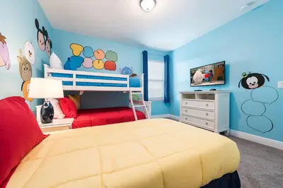 a bedroom with a bed and a tv in it at Encore Resort 5 Bedroom Home with Pool 2100 in Orlando