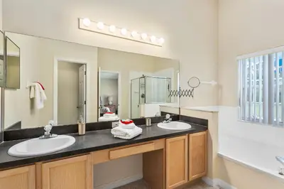 a bathroom with two sinks and a large mirror at South Facing Pool Deck - Private Outlook - Game Room - Family Friendly - Nr Disney in Orlando