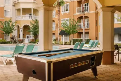 a pool table in the courtyard of a building at The Point by Edge in Orlando