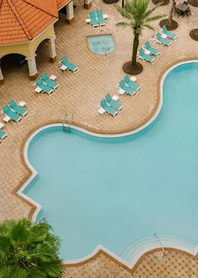 an overhead view of a swimming pool with chaise lounges and a resort at The Point by Edge in Orlando