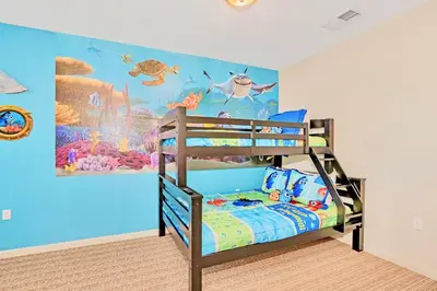 a bedroom with a bunk bed with a fish themed wall at Modern 3BR Near Disney - Pool in Orlando