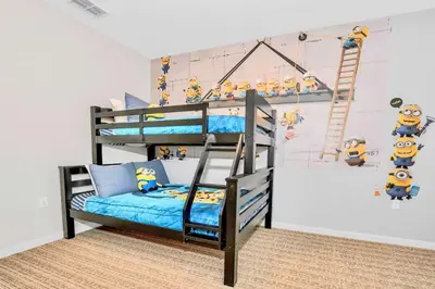 a childs bedroom with a bunk bed and a ladder at Luxury 3BR Near Disney - Pool and Hot Tub! in Orlando