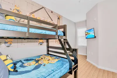 a bedroom with two bunk beds in a room at Refreshing 3BR Apartment Near Disney - Pool and Hot Tub! in Orlando