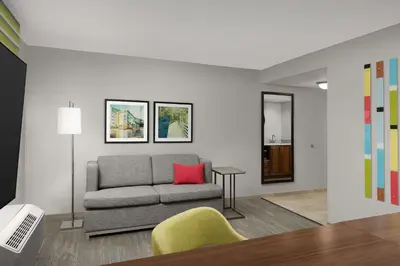 a living room with a couch and a red pillow at Hampton Inn & Suites Orlando North Altamonte Springs in Orlando