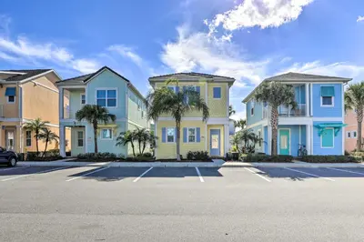 a row of houses with palm trees in a parking lot at Home with Hot Tub 4 Mi to Disney! in Orlando